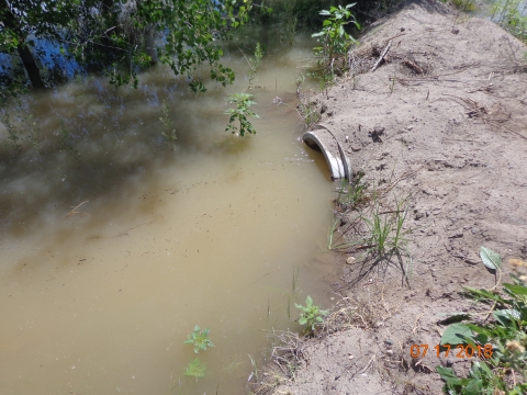 An open pipe in a body of water under the ground