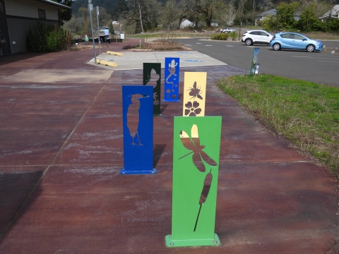 Interpretive metal cutouts for bikes to park and lock.
