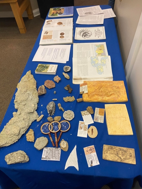 Table with fossils, books, and magnifying glasses