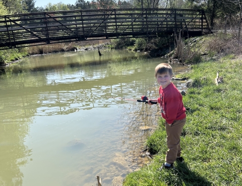 Kid fishing in stream