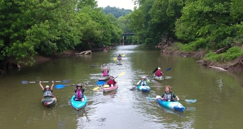 People on kayak traveling on river.