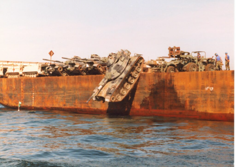 Large vessel drops military tank into the ocean to form artificial reefs