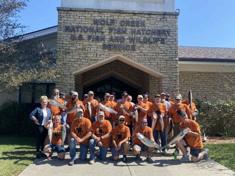 Group of people holding fish