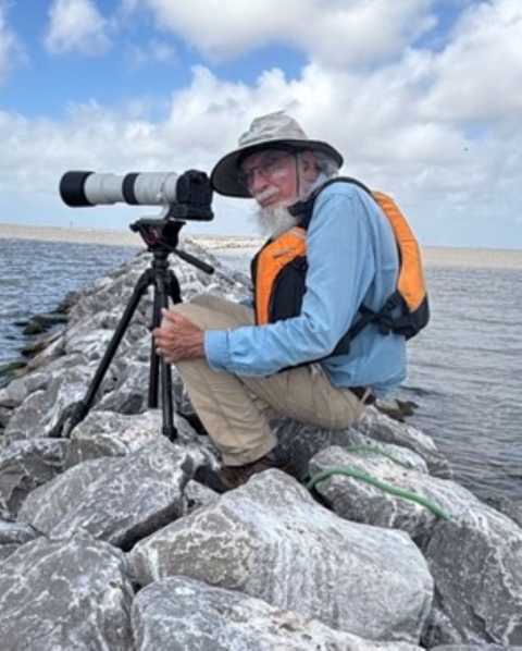 Coastal Program Biologist, Woody Woodrow, photographing birds from a new breakwater constructed to protect Dressing Point Island in East Matagorda Bay on the Texas coast.