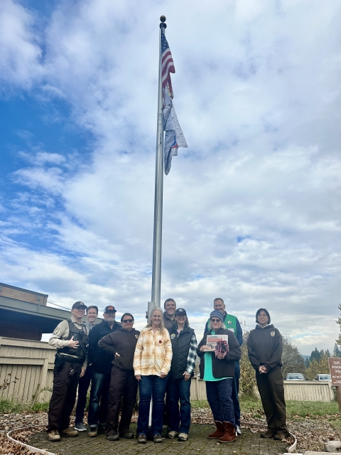 group in front of flagpole