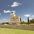 The main campus sign for the University of Texas at San Antonio is pictured in front of a blue sky.