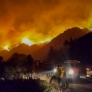 A fire sweeps across a mountainside