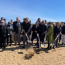 A group of people with shovels 