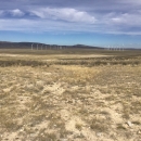 wind turbines in background of rocky Wyoming plains
