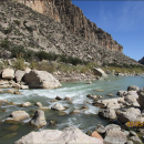 Image of a river showing water flowing over rocks in the river bed