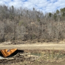 A crumpled shipping container in the Cane River.