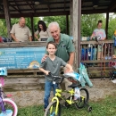 Man in uniform and boy posing with bicycle