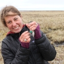 Megan Boldenow holds a bird she helped band for research purposes.