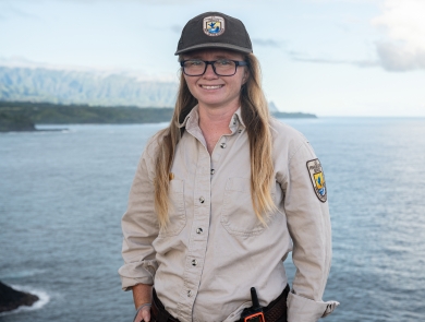 Laurel Smith, smiling in uniform, at Kīlauea Point National Wildlife Refuge in Hawaii. Photo Credit: Angela Iwai-Pineda 