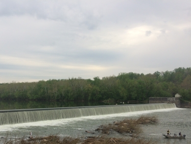 Dam along the Potomac River with a small boat in the water