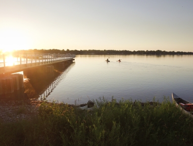 A rising sun shines on a new fishing pier at Detroit River International Wildlife Refuge.