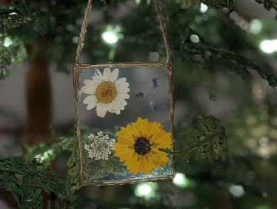 Homemade pressed flower ornament on tree
