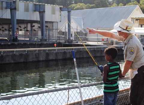 Williard National Fish Hatchery employee Pat Cushman assists with Kid's Fishing Day 2015