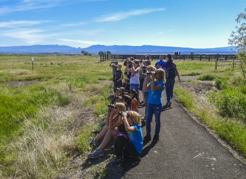 Kids view wildlife using binoculars at Modoc NWR.