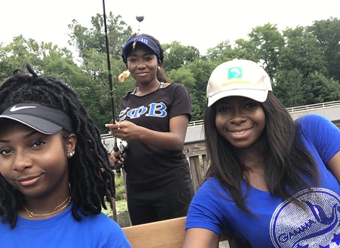 Zeta Phi Beta Sorority, Inc. members Kelsey Burks, Sierra Snyder and Cynthia Ofosu portrait photo at a pier. 