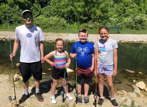 children with fishing poles