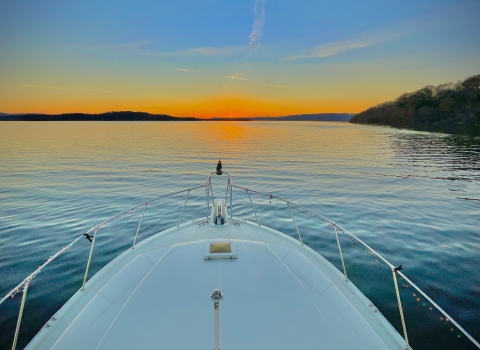 Alabama sunrise over the water, bow of a boat.