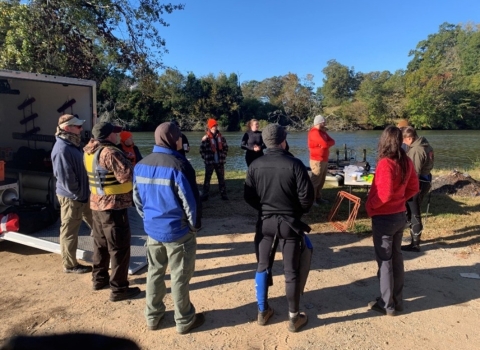 Group photo discussing safety protocols.