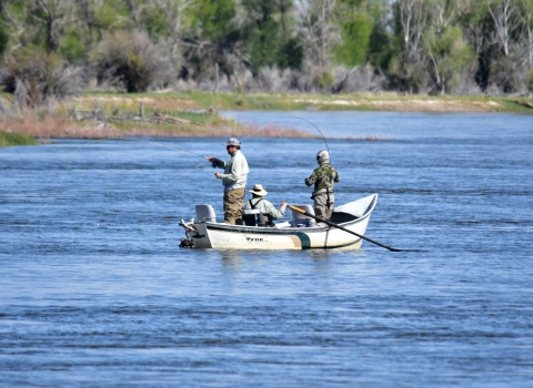 3 people in boat fishing