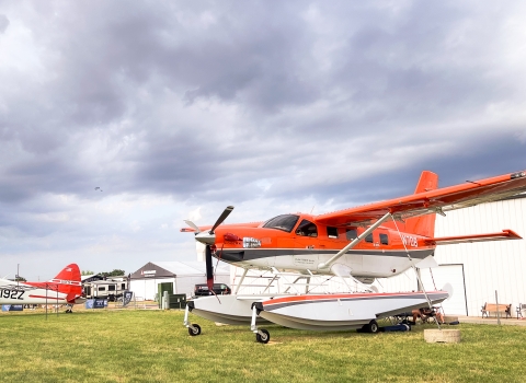 Migratory Bird Program Daher Kodiak survey plane in front of the International Federal Pavilion at EAA AirVenture convention