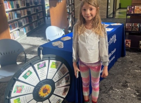 girl standing beside wheel