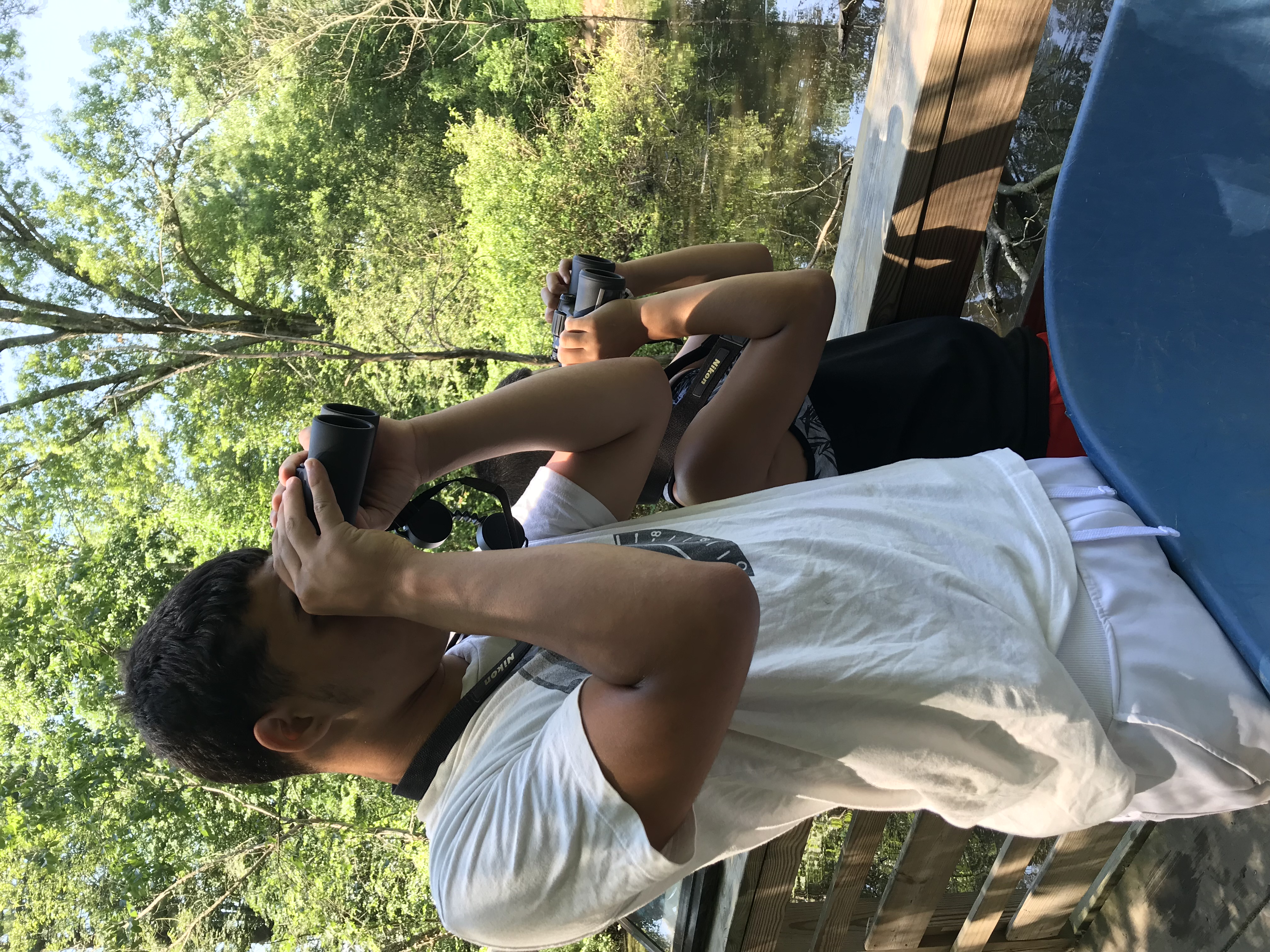 Looking through binoculars at Fort River