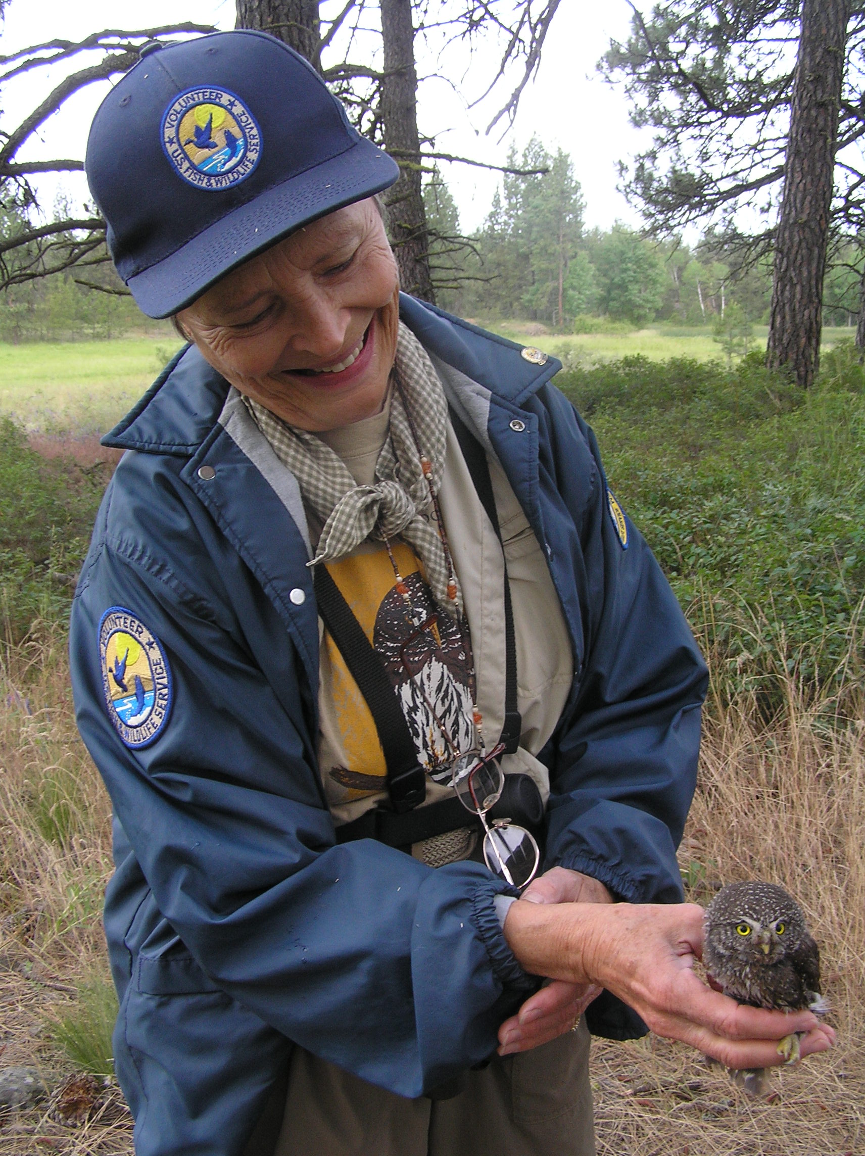 Spokane Audubon member and long term refuge volunteer gets a rare opportunity to hold her Chapter's mascot - a northern pygmy owl.