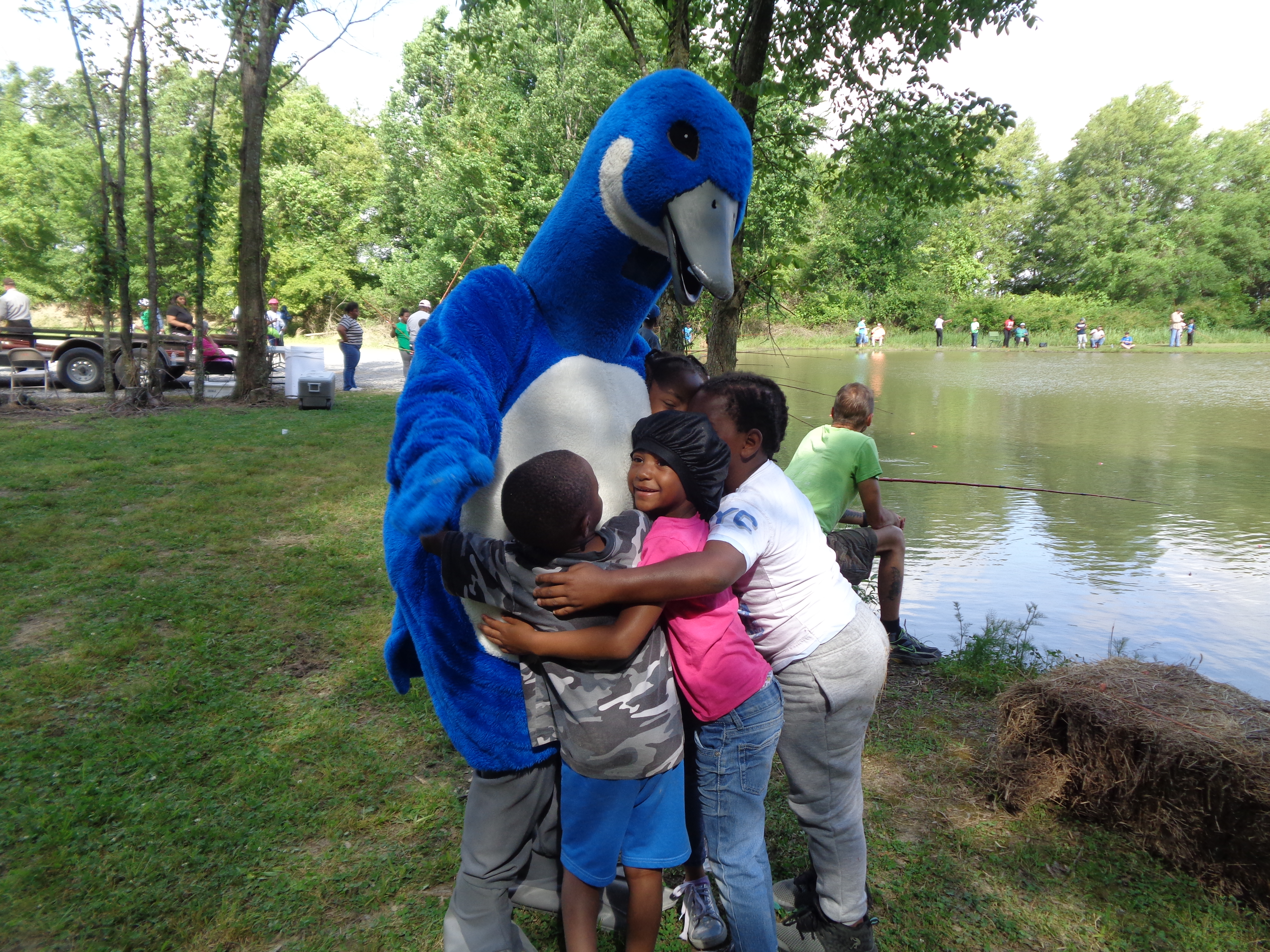Three kids hugging Blue Goose