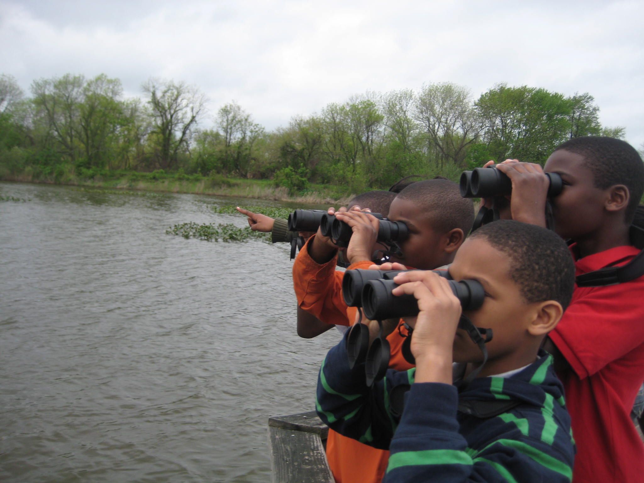 Children use binoculars to view birds along the water at John Heinz National Wildlife Refuge at Tinicum.