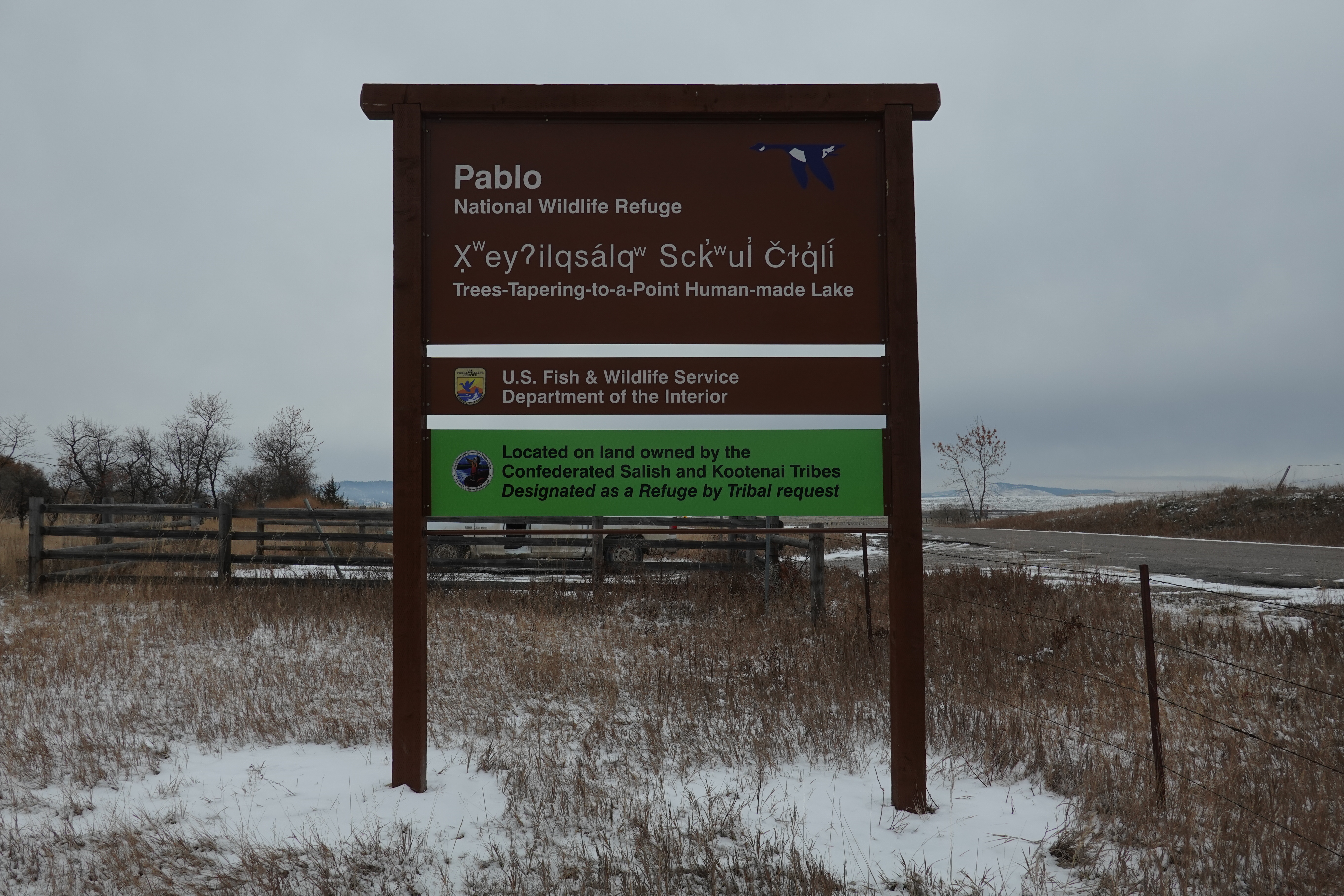 One of the new entrance signs at Pablo National Wildlife Refuge in Salish that states Trees-Tapering-to-a-point Human-made Lake