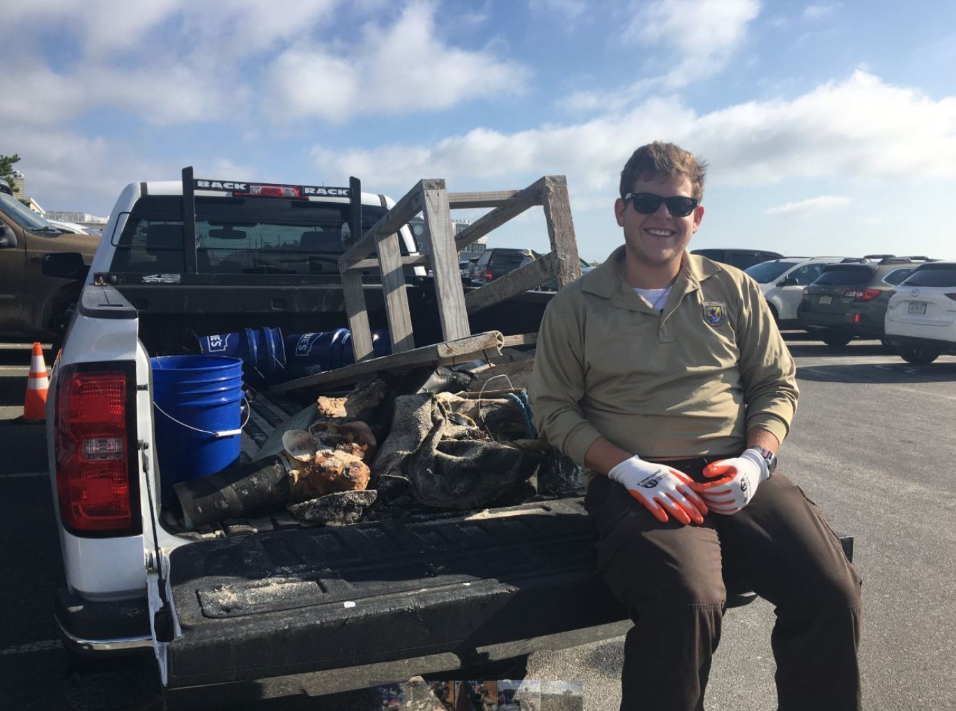 Park Ranger Joshua Baker with a collection of trash found during the refuge's annual Holgate beach clean up.