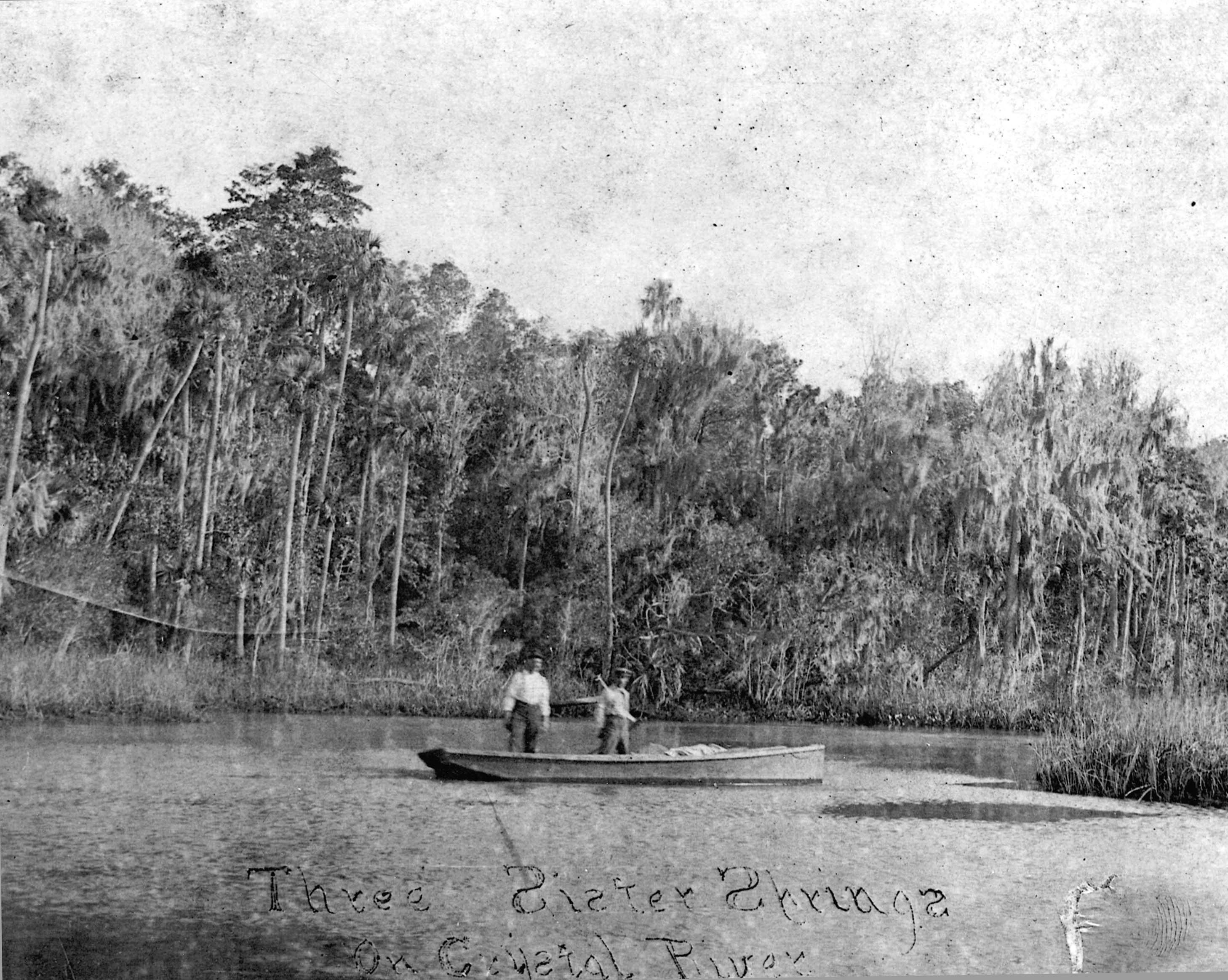 Historic image of Three Sisters Springs and two men on a boat 