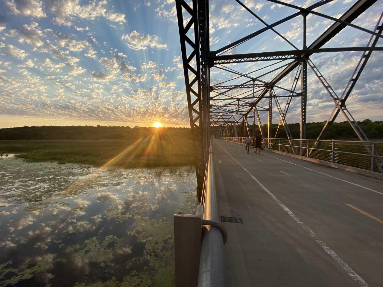 Old Cedar Avenue Bridge over wetland at sunset.