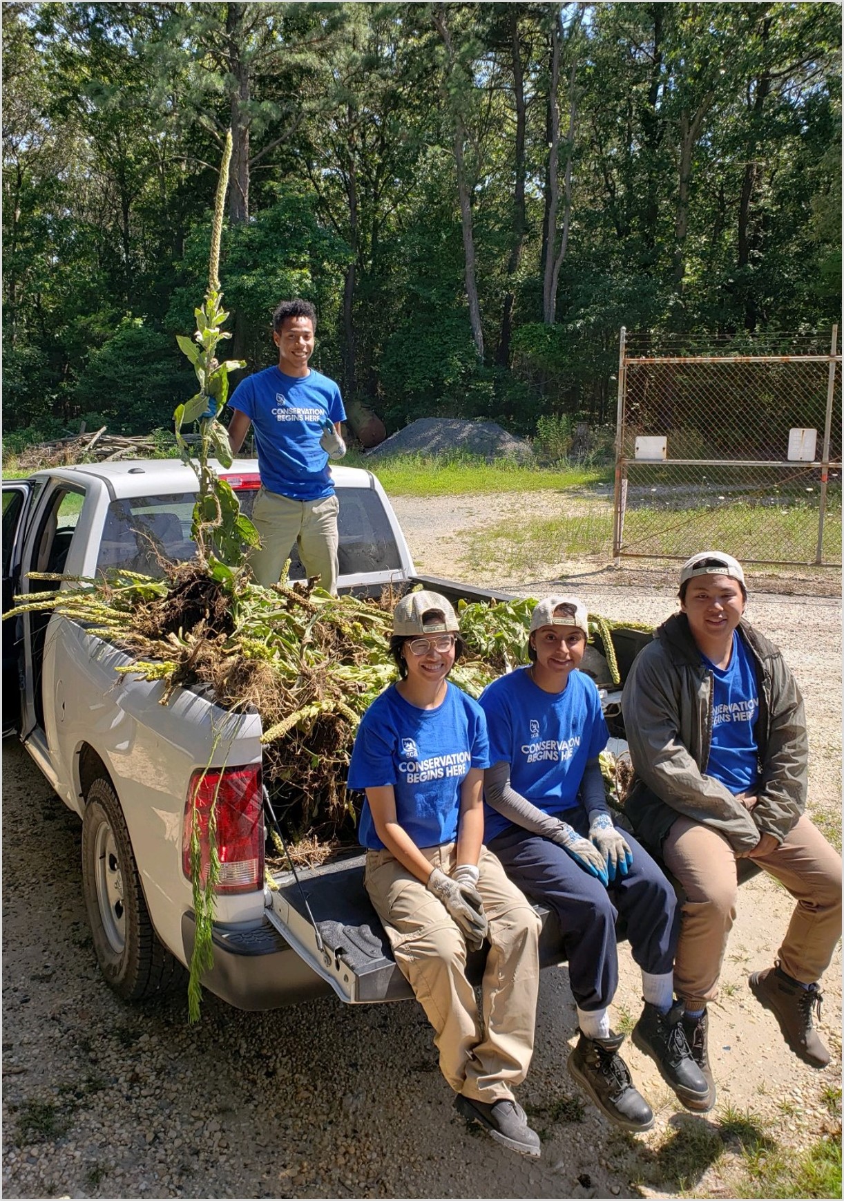 The YCC Crew poses with a pile of invasive great mullein removed from the refuge.