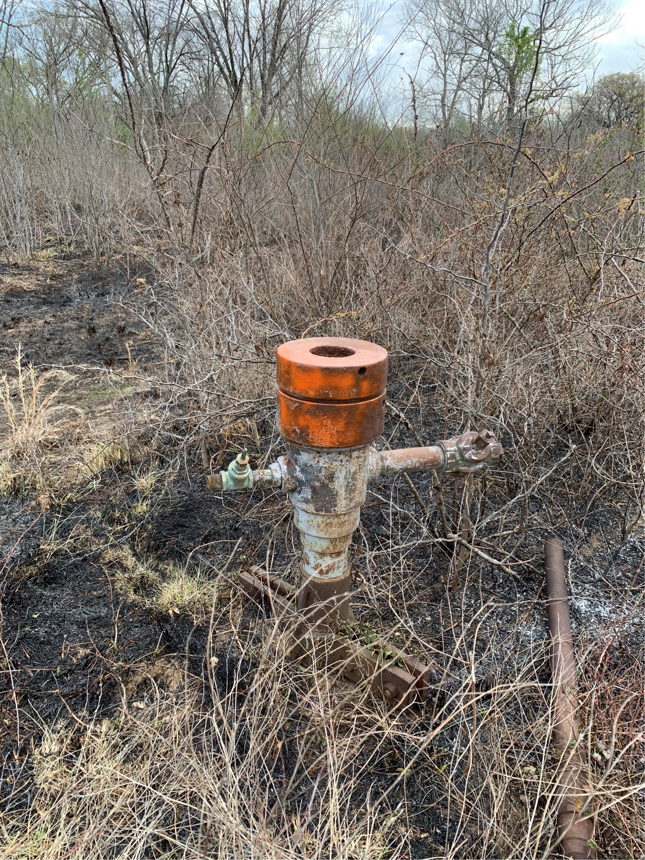 orange topped metal structure in ground