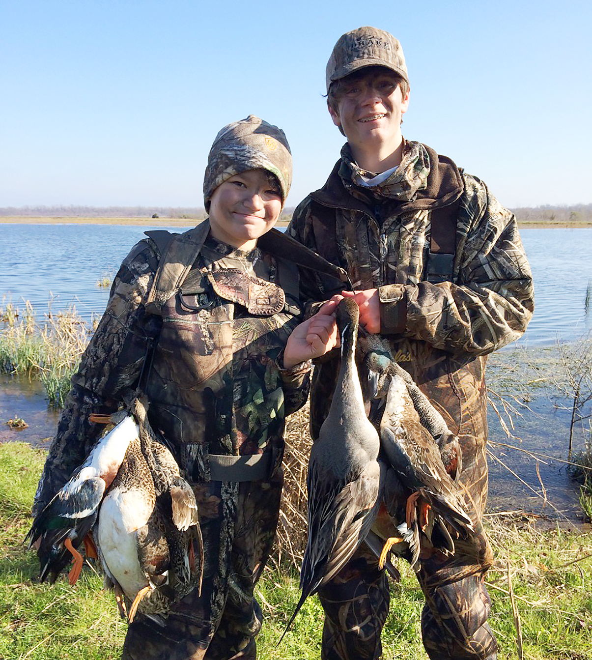 Two Youth, showing waterfowl taken during hunt