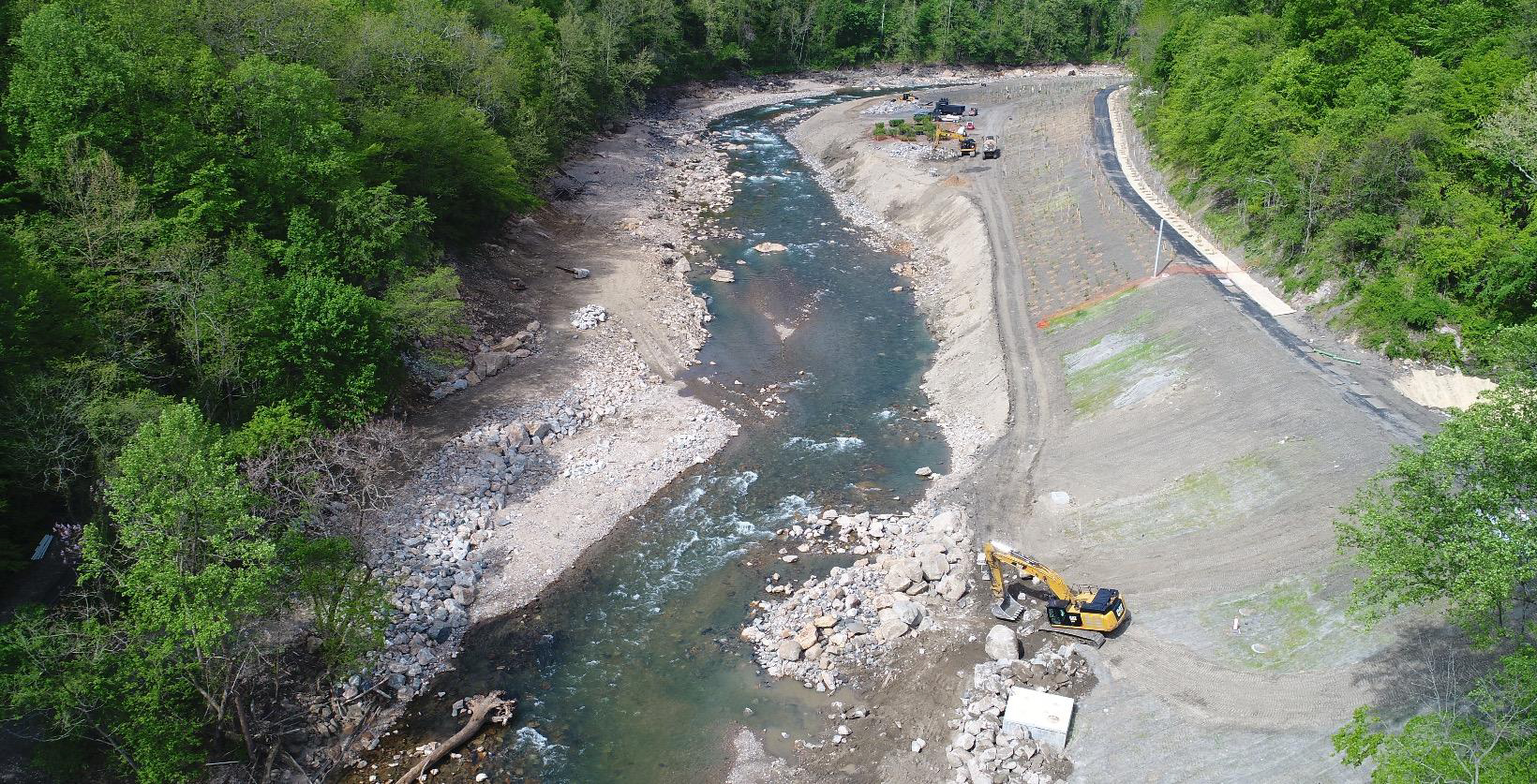 An aerial photo of a bulldozer removing debris from a river