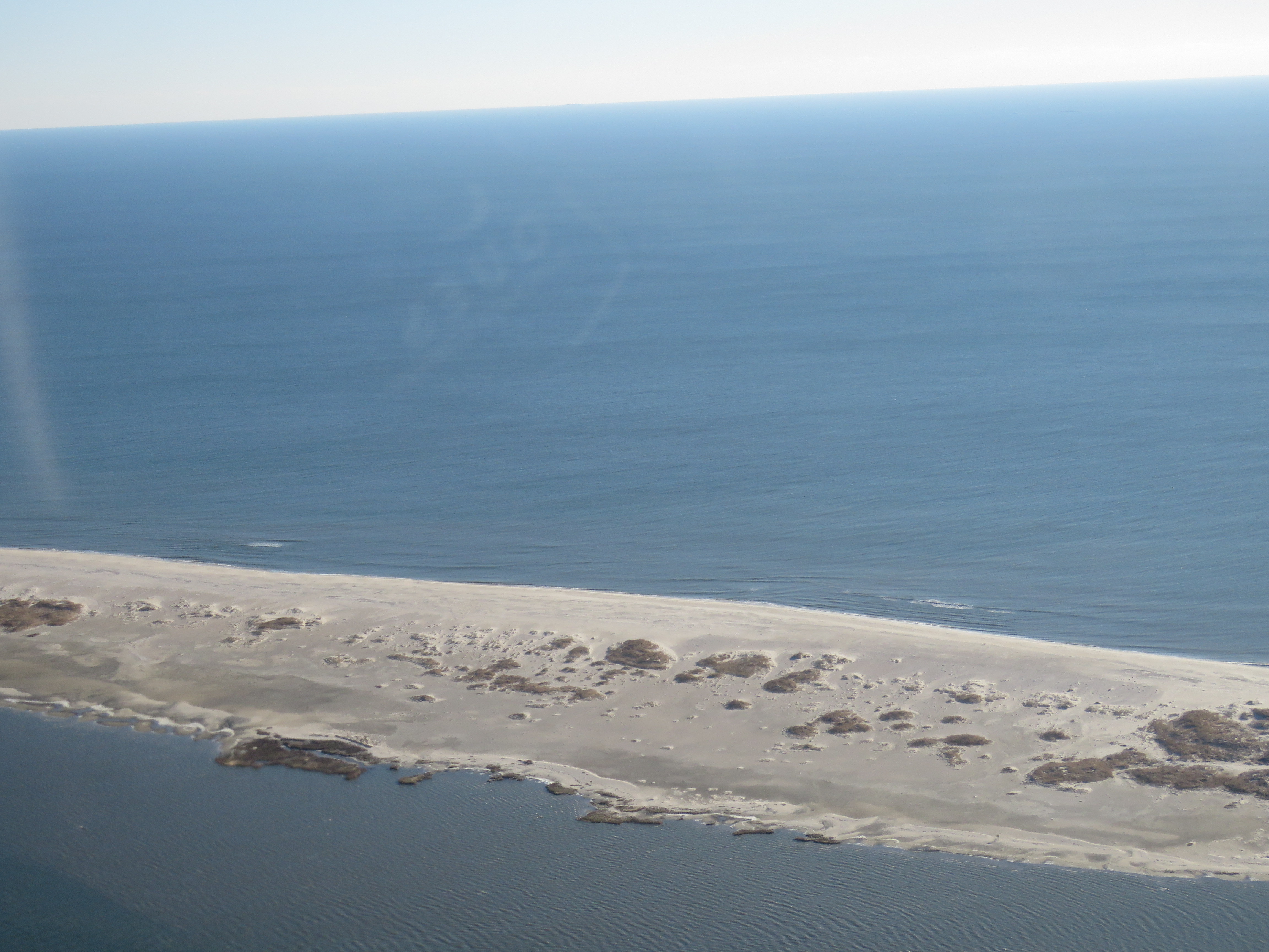 Sandy barrier island with low vegetation 