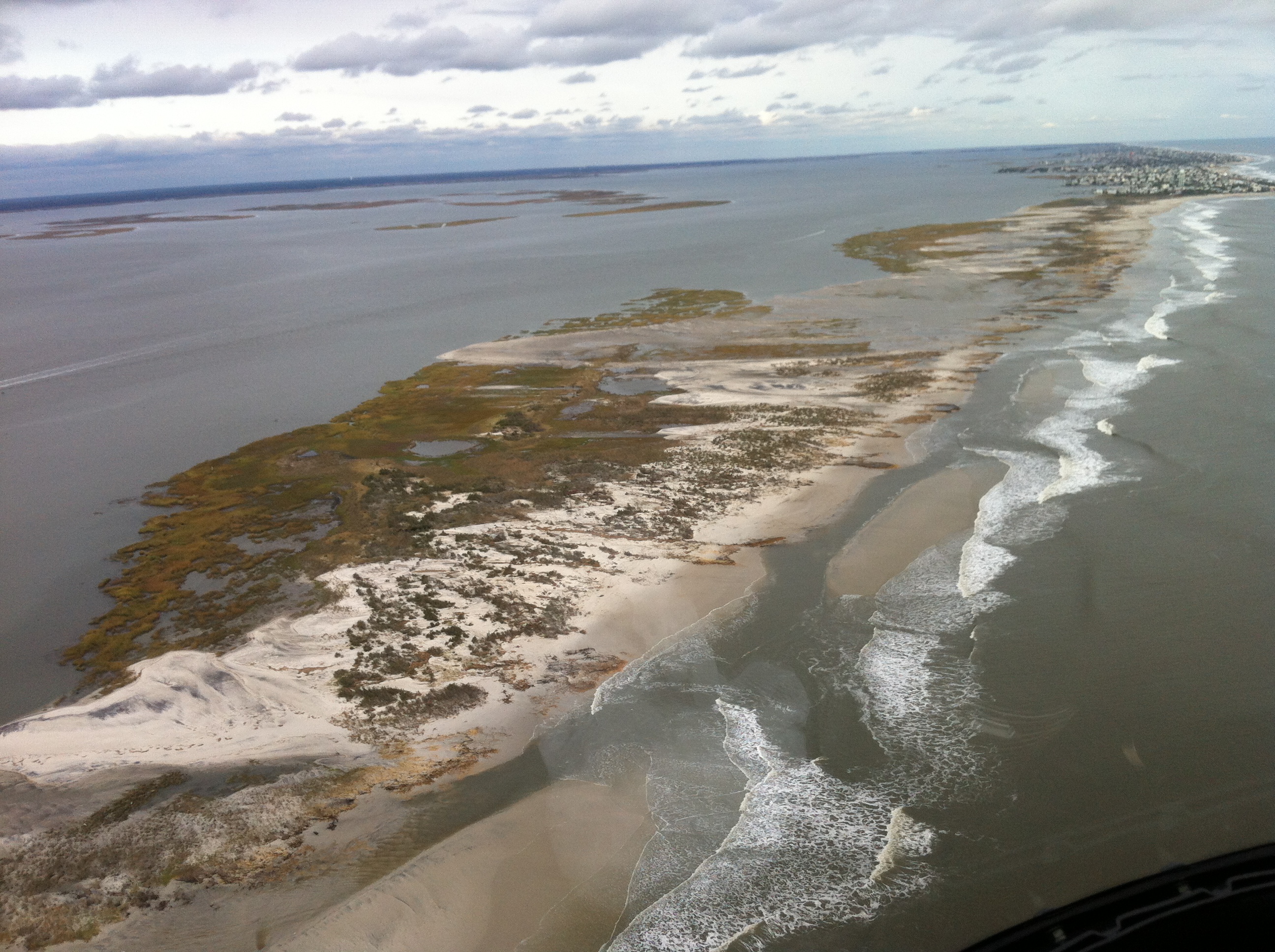 A barrier island is covered with water and sand in the aftermath of Hurricane Sandy