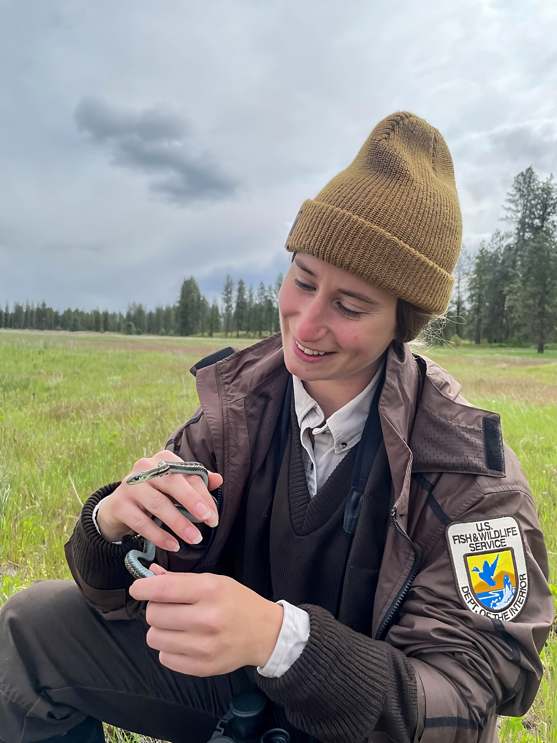 Turnbull NWR - Ranger Holding a Snake (1) | FWS.gov