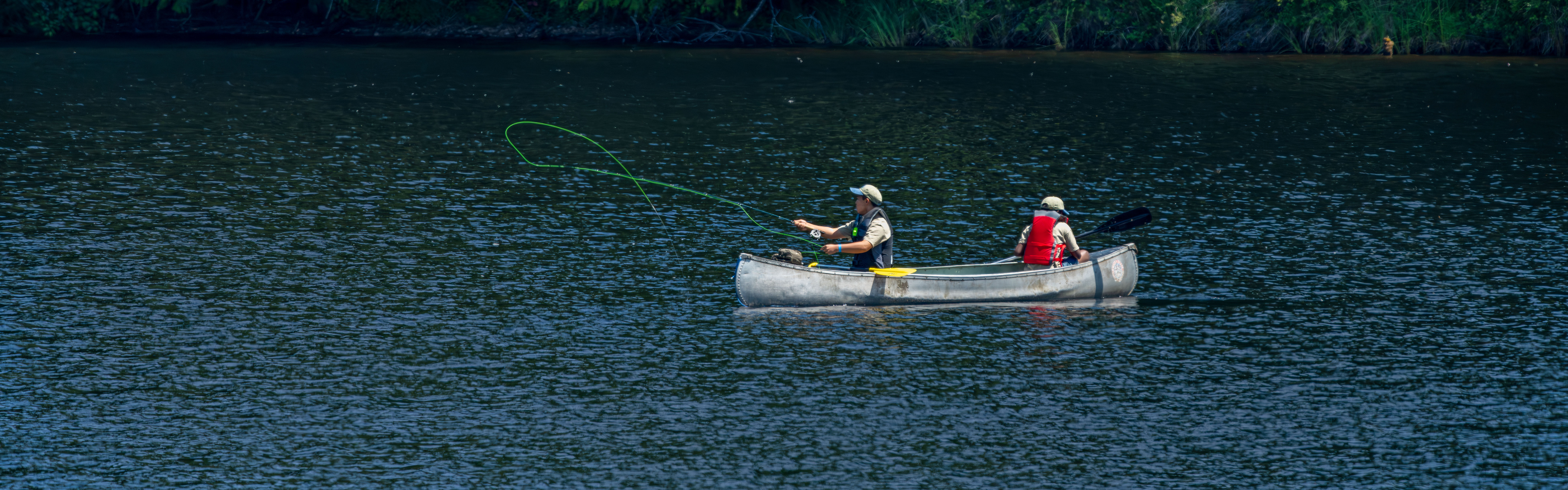 Two campers fly fishing from a canoe at the Northwest Youth Fly Fishing  Academy.jpg