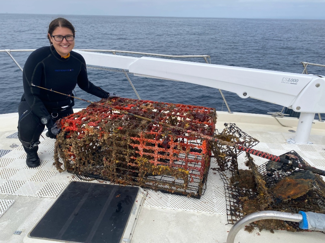 Abigail Sanford posing with a lobster trap