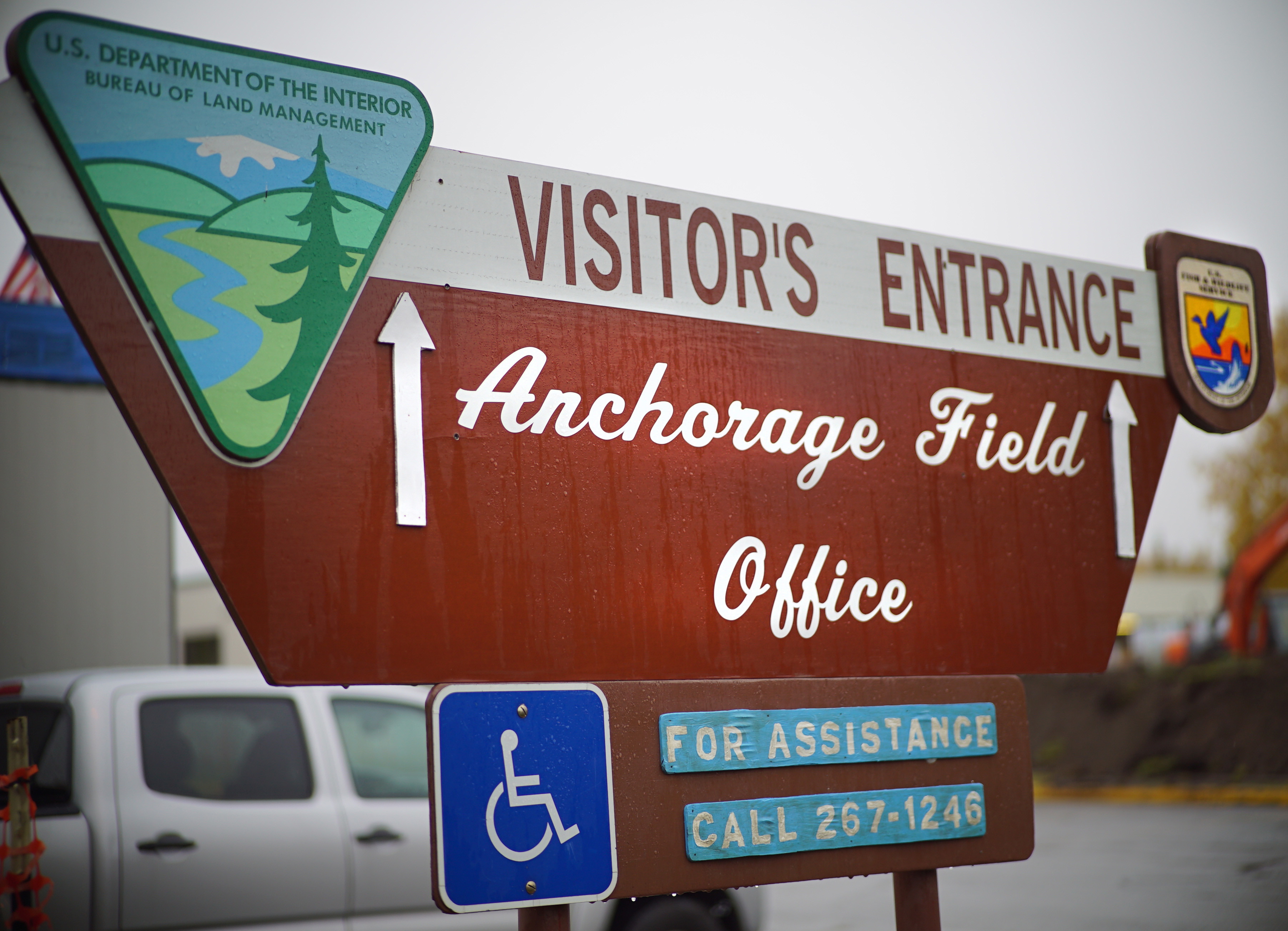 anchorage field office sign that's brown with logos in each corner