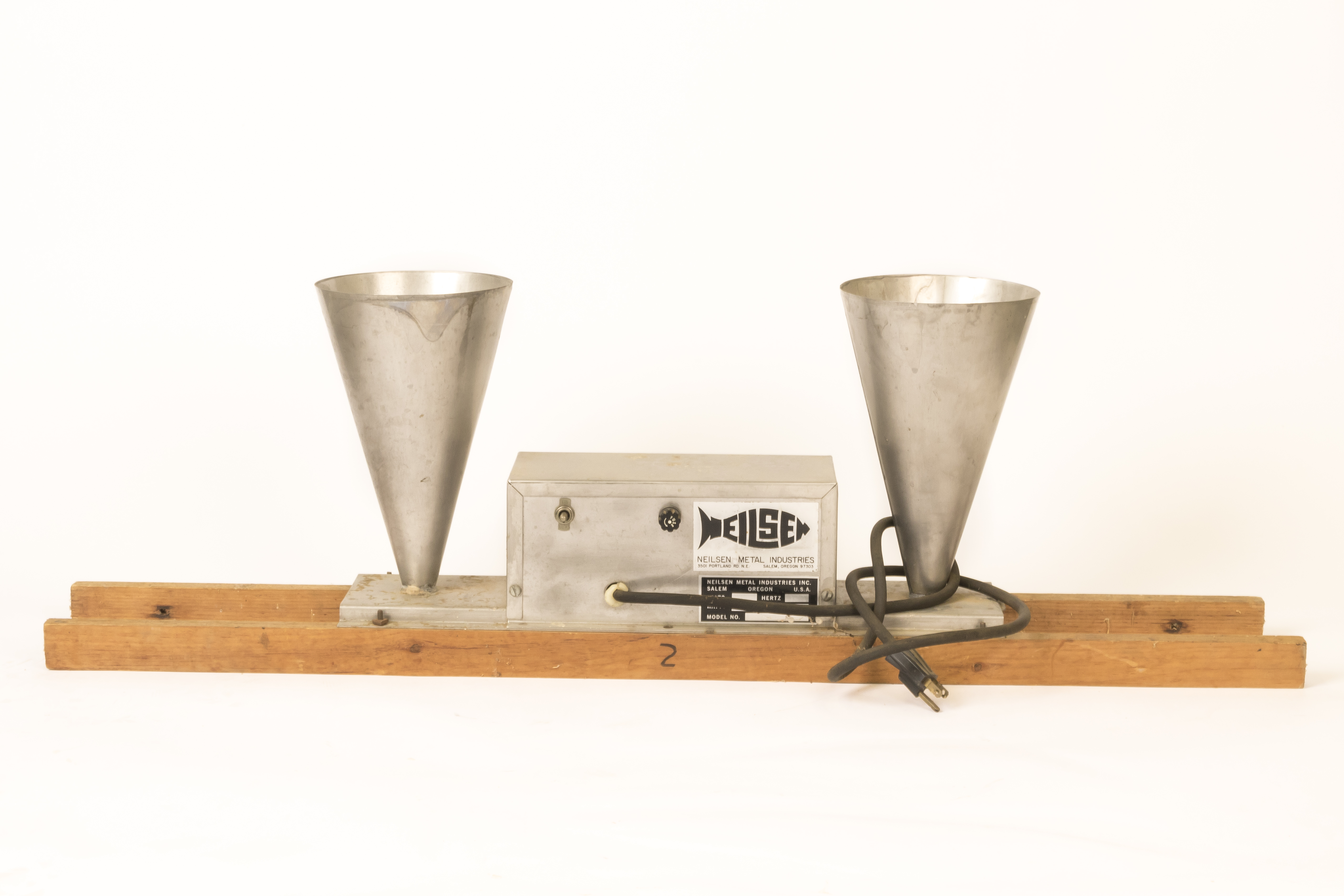 A grey metal Neilsen automatic fish food feeder photographed on a white background.