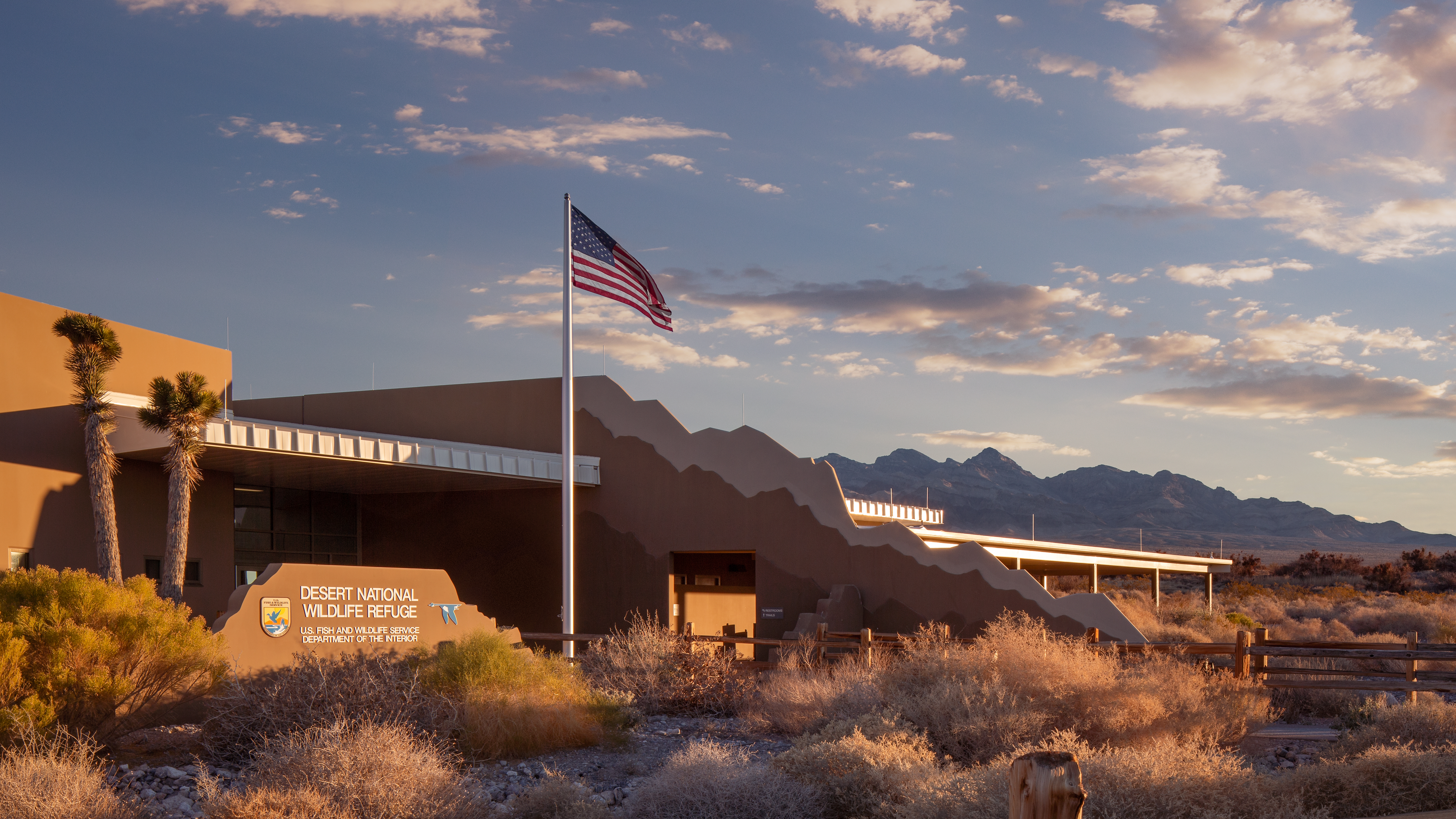 Front of Corn Creek Visitor Center at Desert National Wildlife Refuge. Mountains visible in the distance.